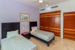 Guest bedroom with 2 single beds and flat screen HDTV